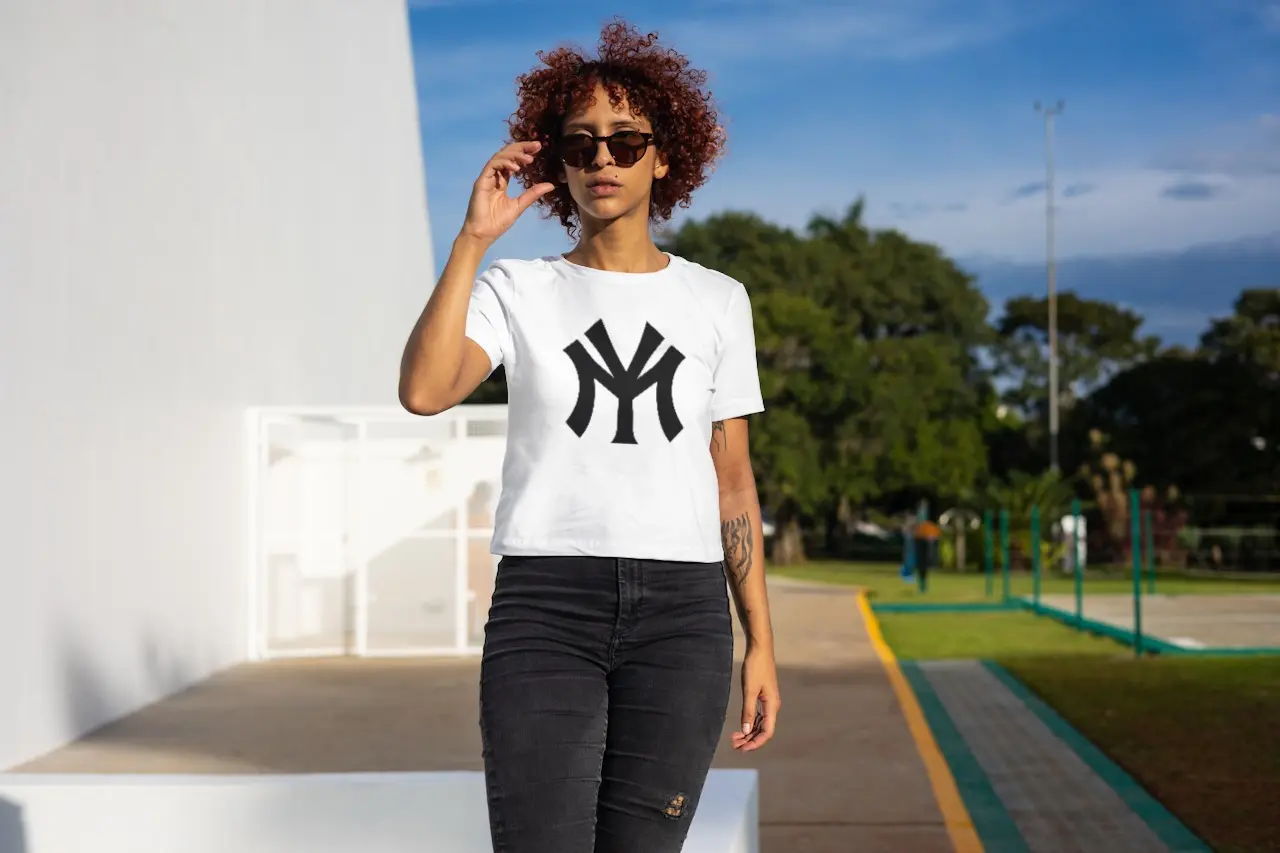 Woman wearing a white shirt with black Mississippi Yankees design